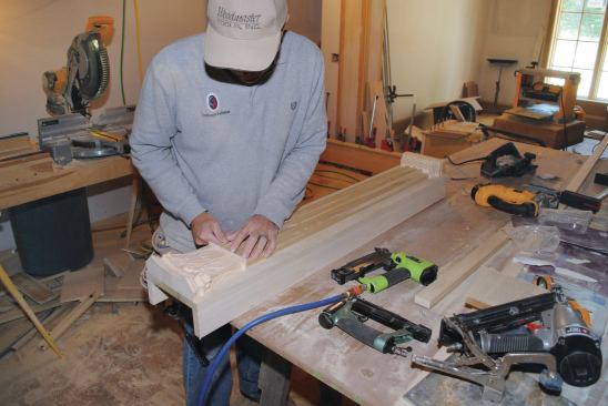 Pilasters smaller than the ones below the mantel are fabricated with molding made to look like fluted columns.