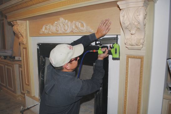 A decorative frieze board fits between the pilasters to visually support the mantel.
