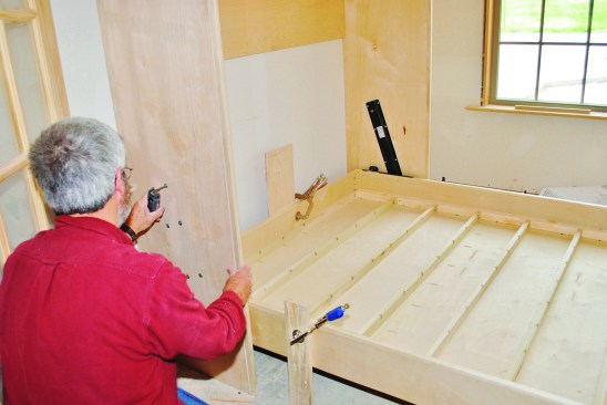 Because I was working by myself, I clamped temporary legs to the platform to support it while I lined up the bolts to join the platform to the cabinet.