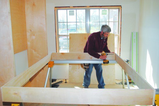The bed platform starts with a 6 3/8-inch-deep plywood box. When building the box, I joined the sides to the head and foot to cover the plywood edges so the only time the edges are visible is when the bed is down.
