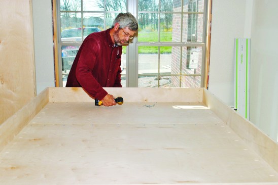 For strength, I built the bed platform with a 3/4-inch-plywood bottom. The two plywood pieces fit inside the sides and I pocket-screwed them in place.