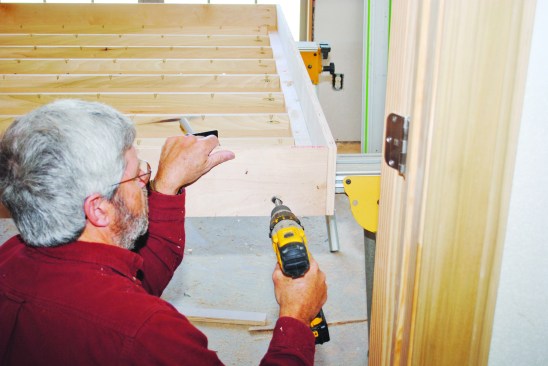 To install the fold-down feet, I located and drilled holes in the outside end of the bed according to the manufacturer’s instructions.