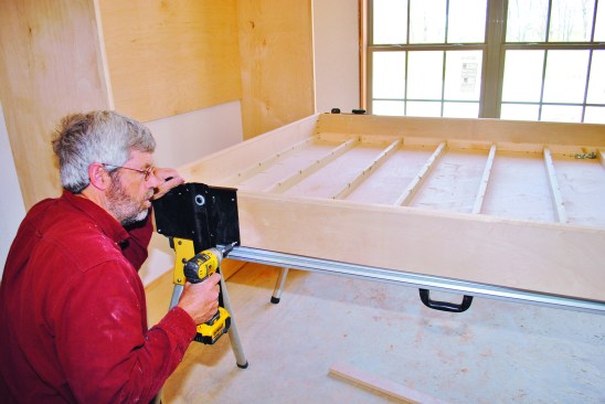 To attach the hinge hardware, I started by drilling holes and attaching the bracket to the platform.