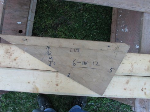 A simple rafter jig helps with laying out the eaves details. The triangle has the plumb line on one leg and the level line on the other, so it is also handy for drawing cutlines. Information such as number of degrees and length of hypotenuse in a base one triangle are also included for reference.