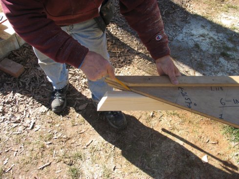 For the lower long point on the gable plate, mark the pitch angle on one end using the rafter jig. Square across the stock and mark both edges.