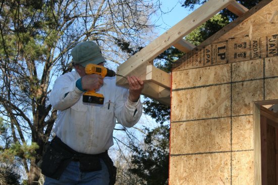 The block provides attachment for the triangular piece that fills in the end of the return. The face stays in plane with the barge rafter and the bottom edge lines up with the blocking for the soffit.