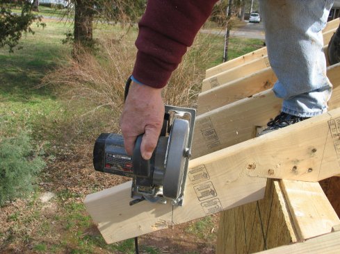 Cutting the rafter tails from above causes the kerf to open naturally as you cut, and it lets the waste fall away harmlessly.