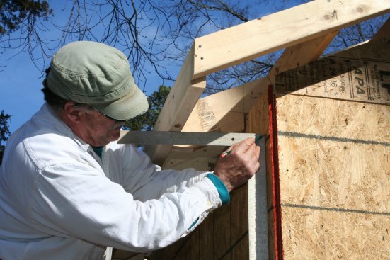 After the subfascia is installed, a line is squared over to the sheathing to locate the ledger for attaching the soffit.