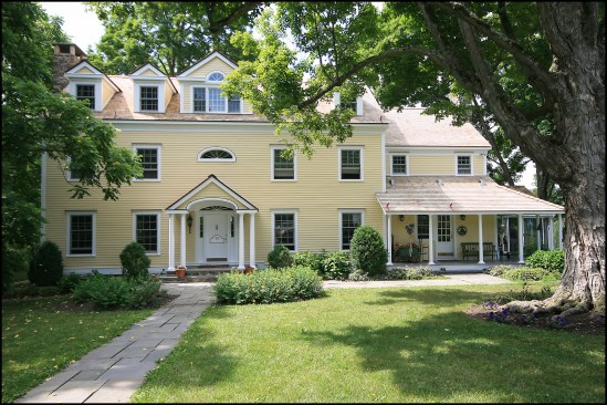 Completed restoration. In the end, our clients were pleased with the restoration. All told, replacing the home’s trim, siding, and windows took about 950 man-hours to complete. One wonders how many more years the homeowners would’ve got out of their exterior cladding had the existing trim and siding been properly primed and flashed—not to mention the direct correlation to poor window head flashing and damage to about half of the home’s windows.