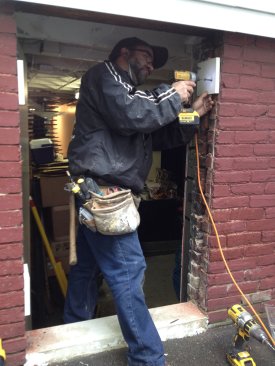 After the threshold is poured, 1-by PVC pads are screwed into the brick on either side of the opening. The pads span the gap between the layers of bricks to help stabilize them.