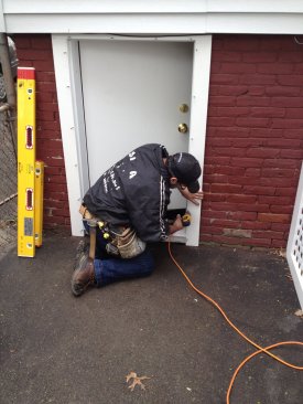 The exterior trim kit attaches to the door jamb. The screw holes are filled with plugs that are cut flush with the face of the trim.