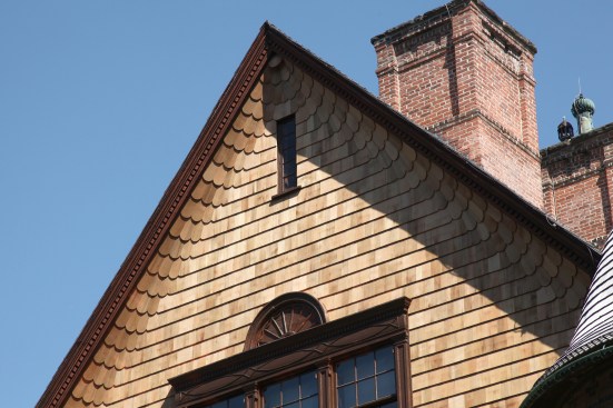 The restoration crew replicated the curved scalloped shingles along the gable eaves.