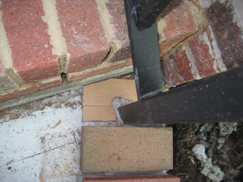 To fit odd-shaped areas such as the one around the railing post, the author first rough-cuts a brick-shaped cardboard template to fit against the steps and looselyaround the post. 