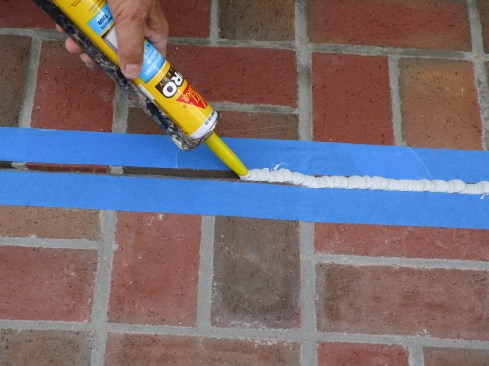 The author fills the control joint with a polyurethane-based caulk made specifically for use with concrete and masonry.