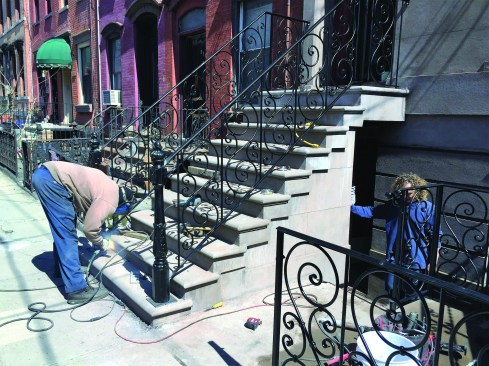 Ironwork is an important but extremely expensive part of a stoop repair. Usually, the old ironwork is salvaged with wire brushes and new paint, but occasionally the author has a chance to replace it entirely to good effect.