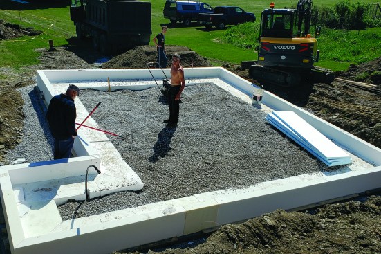 Next, they even out the ground inside the forms with a fresh layer of crushed stone, compacting the layers as they go.