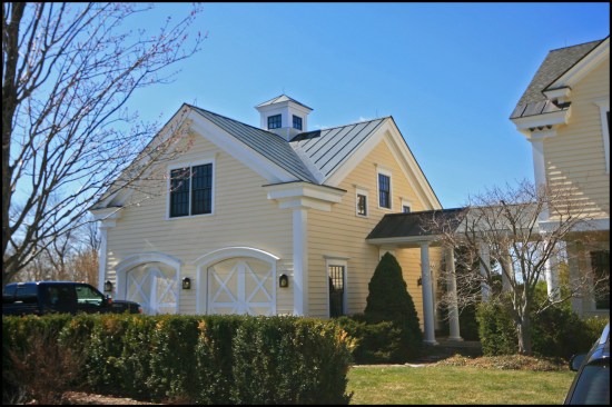 Located on an attached carriage house, the two segmented-arch-top garage doors were shop-built and made out of mahogany.