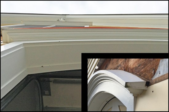 The sloped drip cap (inset) made a tricky flashing job even trickier. The length of the head flashing was already an issue for on-site fabrication (two pieces of roughly 6-foot-long flat stock, lapped in the center, were needed for each door). When laid in place, the copper flat stock overhung the cap in the center a little more than an inch (main photo). The slope changed the geometry enough to where the flat stock needed to be crescent-shaped to fit properly.