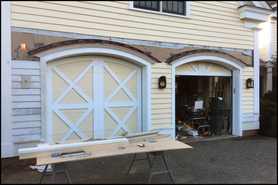 Repaired carriage house wall and archtop garage doors.