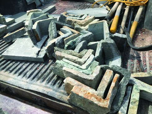 The crew uses factory-cut corner pieces for the 90-degree corners.