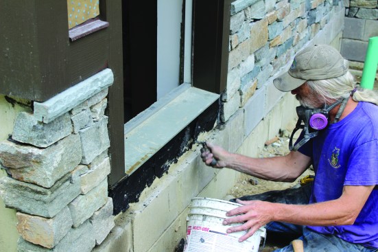 Then a layer of mortar is spread on the foundation.