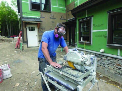 The masons use a heavy-duty wet saw to cut the stone veneer when needed. The saw has a tilting head for cutting miters.