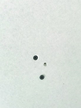 The heads of screws that miss the framing will be proud of the drywall surface, as illustrated by the lower screw in this photo.