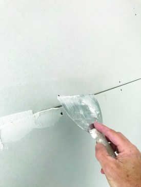 The tapers will follow, going over these cracks with mesh tape and compound.