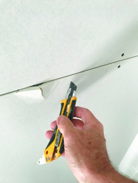 Repairing a damaged edge begins with slicing the paper around the damage ...