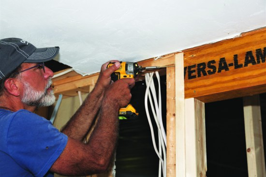The first screws attach the kings to the header beam.