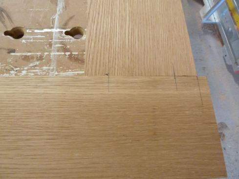 We laid the door parts flat on our bench and struck marks for the centerline of each tenon on the face of each intersecting stile and rail.