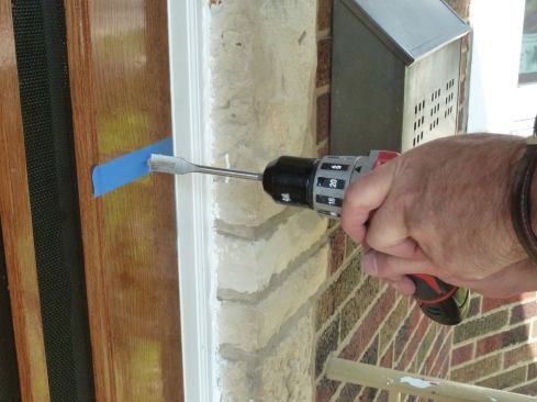We drilled for and installed a traditional storm-door latch in the strike side of the door, along with a heavy-duty pneumatic closer mounted on the bottom rail. Finally, we stained and varnished any bare wood that was exposed during the fitting process and inserted the screen panel to complete the installation.