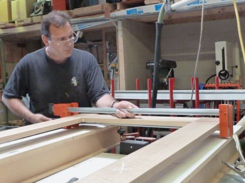 We tightened the clamps and added a second set of clamps on top of the door. Once those clamps were tight, we sighted down the length of the door to be sure that the top pair of clamps were dead parallel, which meant that the door was perfectly flat.