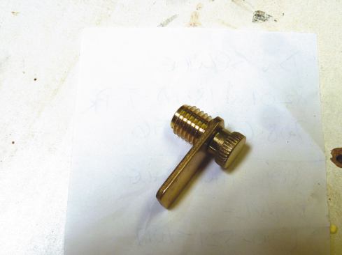 These thumb screws attached with a machined thread, so we first embedded solid brass threaded inserts in the door to accept the thumb screws.