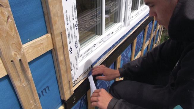 The window's edge is sealed to the taped sill dam using Pro Clima Tescon Vana tape to form an inner airtight and watertight seal.