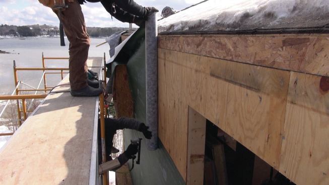 To connect the roof and wall air control layers, the open rafter bays are sheathed over and the DA membrane is extended up past the roof edge.