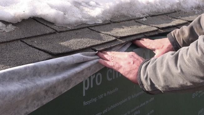 The DA fabric is tucked underneath the shingles. Later, the roofing crew would seal the DA membrane to the roof while applying Grace Ice & Water Shield self-adhering membrane to the roof.