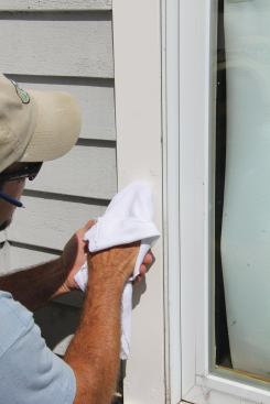 Before the spackle sets, wipe any residue off using a damp rag.