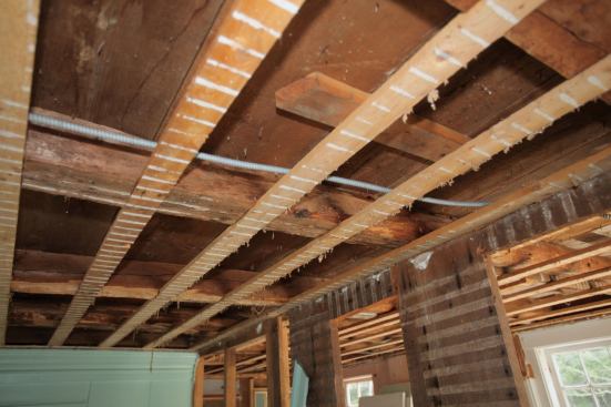 My understanding is that installing strapping originated from the need to create a flat surface for attaching the ceiling to the uneven hand-hewn timbers once used as structural framing members. Carpenters shimmed the strapping down to the lowest point in the room and then attached the finish material. While we no longer need to shim the strapping to achieve a relatively flat ceiling, the board hangers that follow behind us appreciate a full 2 1/2 inches to attach the board to rather than the 1 1/2 inches provided by dimensional lumber.