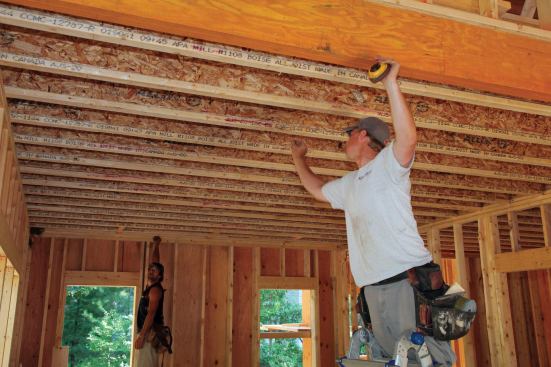 We strap the ceilings after all ceiling and bearing-wall framing is finished. Working in teams of two, each carpenter begins by laying out an end of the room at 16 inches on-center. When the entire room is laid out, we snap chalk lines on the ceiling to ensure a straight and clean installation.