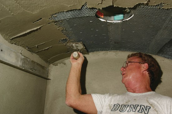 A layer of mortar is smoothed  onto the wire mesh with a trowel. When the mortar dries, the tile installs over the mortar with thinset.
