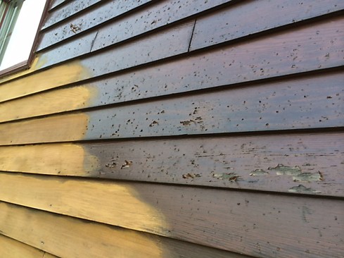 The Sikkens was showing signs of failure prior to the storm, as well. On sunny, exposed areas it was peeling. In some protected areas, such as under roof overhangs and on the one side of the building undamaged by hail, the finish was not pockmarked and was still well bonded to the siding and trim. But on the whole, the finish was beyond repair and needed to be replaced.