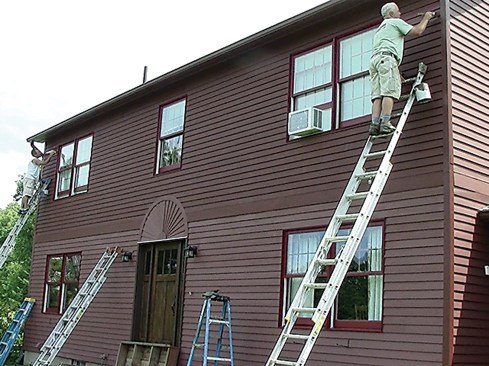 For the finish coat, we used Sherwin Williams’ Duration Satin on the trim and Sherwin Williams’ Woodscapes on the siding. Woodscapes is a solid stain with a flat finish and is good for hiding all the cosmetic defects left over from removing the Sikkens. We applied the topcoat in the same way we applied the primer - generously, wet and continuously. Todd and I had to work fast to keep the materials flowing in the hot summer sun, applying it in sections that we could cover alone (between windows) …