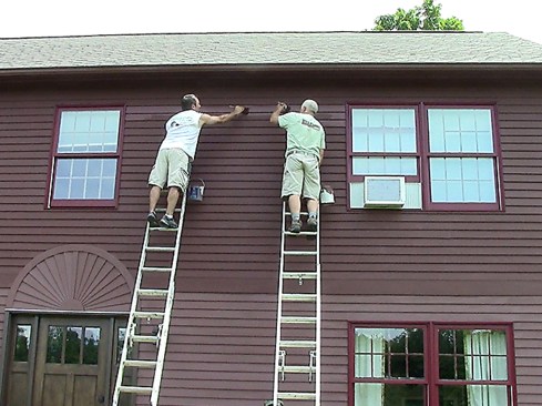 ... and working together on sections where we needed to blend longer runs into each other's work to avoid flashing. We like using 2 1/2” Purdy XL medium/stiff angled brushes to apply the primer and topcoat. They work well for applying finishes liberally and fast in order to keep the surface wet. This size of brush works well on clapboard reveals to spread paint in long passes, while still allowing us to point and cut where needed.