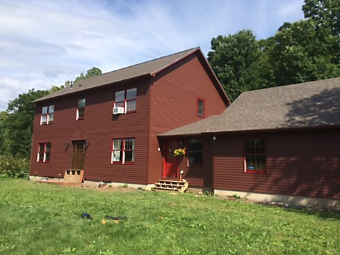 A surface restoration like this costs about twice as much as a straight-up exterior repaint, but it's still significantly less than a siding replacement. It was the appropriate option, because despite the failed coating, the cedar siding underneath still had a lot of life left in it. The finish system we installed will last for many years, although we expect by the third year it will need some touch-up in high exposure areas. 