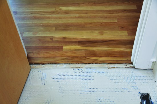 Designed to add stiffness, Permat is not a waterproofing membrane. It was laid into a bed of thinset, and then its open mesh was filled and floated with more thinset. 