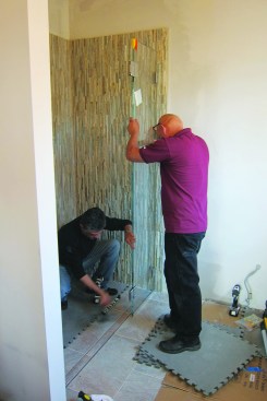In preparation for the glass enclosure, a stainless steel U-channel was bedded in silicone and secured with stainless steel screws to receive the sidelight at the floor.