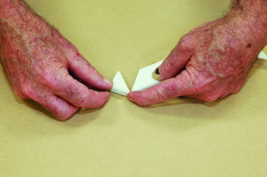 Because the glue sets quickly, I "hinge" the joint closed to align the miter.