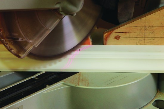 At the opposite end of the molding, mark the measurement on the same part of the profile, where the miter will pass through the bottom fillet.