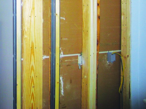 The electrician rerouted the wires through the floor, and we moved the outlet box to the bay next to the pocket.